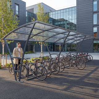 Armstrong 30 cycle bike shelter in Anthracite Grey at a modern business school campus with bicycles parked