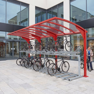 Rydale cantilever two-tier 30 bike shelter in Traffic Red at a shopping centre