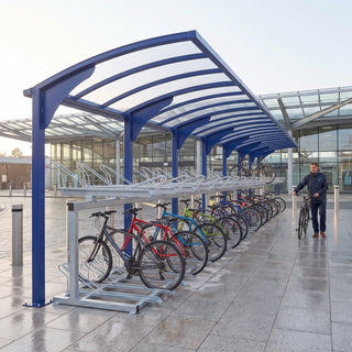 Rydale cantilever two-tier 60 bike shelter in Ultramarine Blue at a railway station