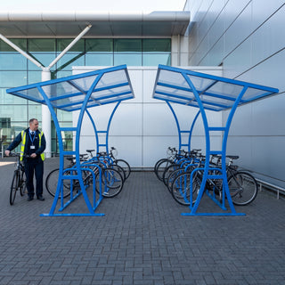 Double-sided 20 bike shelter in signal blue at an airport staff bike parking area