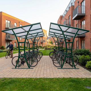 Double-sided 40 bike shelter in fir green at a residential apartment complex