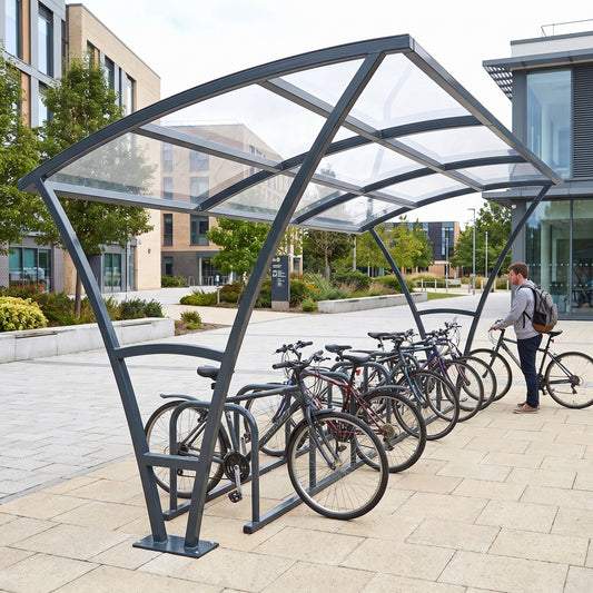 Armstrong 10 cycle bike shelter in Anthracite Grey, end view on a university campus with bicycles parked