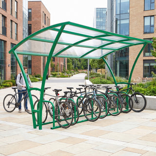 Armstrong 10 cycle bike shelter in Traffic Green, front view on a university campus with bicycles parked