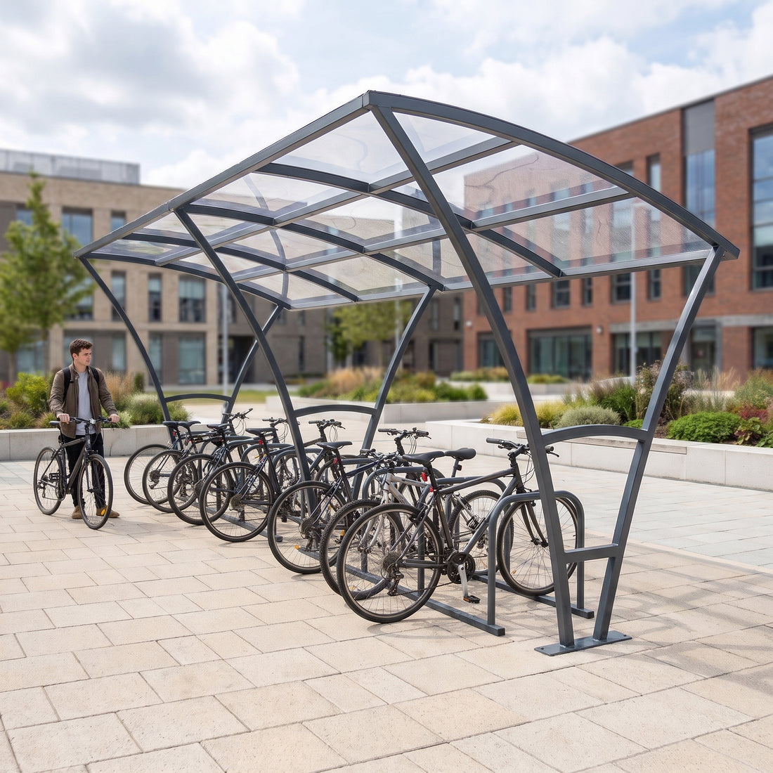 Armstrong 20 cycle bike shelter in Anthracite Grey on a university campus plaza with bicycles parked