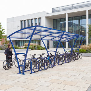Armstrong 24 cycle bike shelter in Ultramarine Blue in a modern university library courtyard with bicycles parked