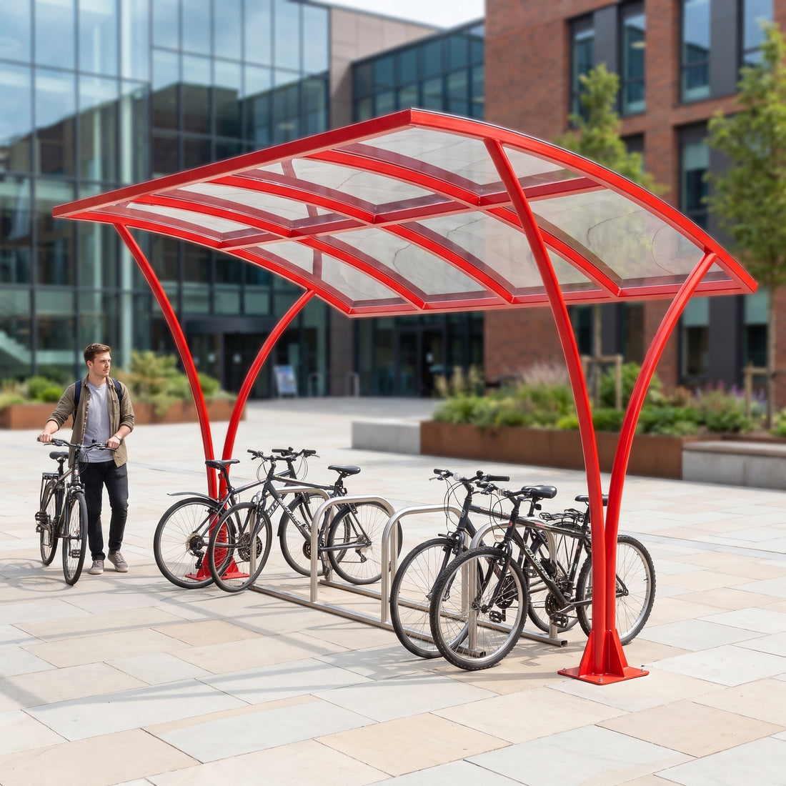 Armstrong CHS 10 cycle curved bike shelter in Traffic Red installed on a university campus with bicycles parked