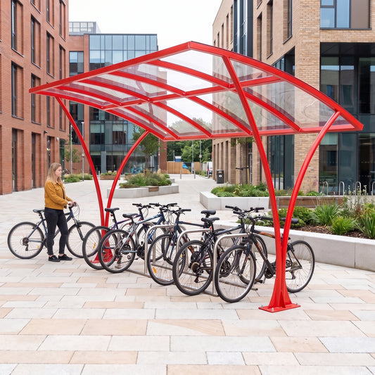 Armstrong CHS 12 cycle curved bike shelter in Traffic Red installed on a university campus with bicycles parked