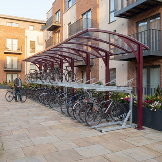 Rydale cantilever two-tier 80 bike shelter in Wine Red at a residential apartment courtyard