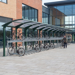 Rydale Cantilever two tier 100 bike shelter in RAL 6005 Moss Green at a railway station