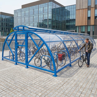 60 cycle Salisbury closed compound bike shelter with vented roof in RAL 5017 Traffic Blue at a waterfront commercial development