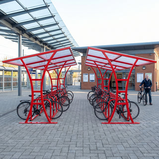 Double-sided 40 bike shelter in traffic red at a railway station