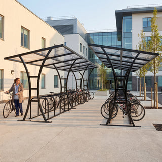 Tavistock Double 48 bike shelter in Jet Black at a hospital staff parking area