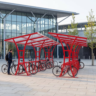 Tavistock Double 48 bike shelter in Traffic Red at a railway station forecourt
