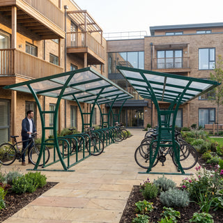 Tavistock Double 60 bike shelter in Fir Green at a residential apartment courtyard