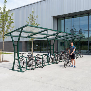 24 bike cycle shelter in fir green outside a sports and leisure centre